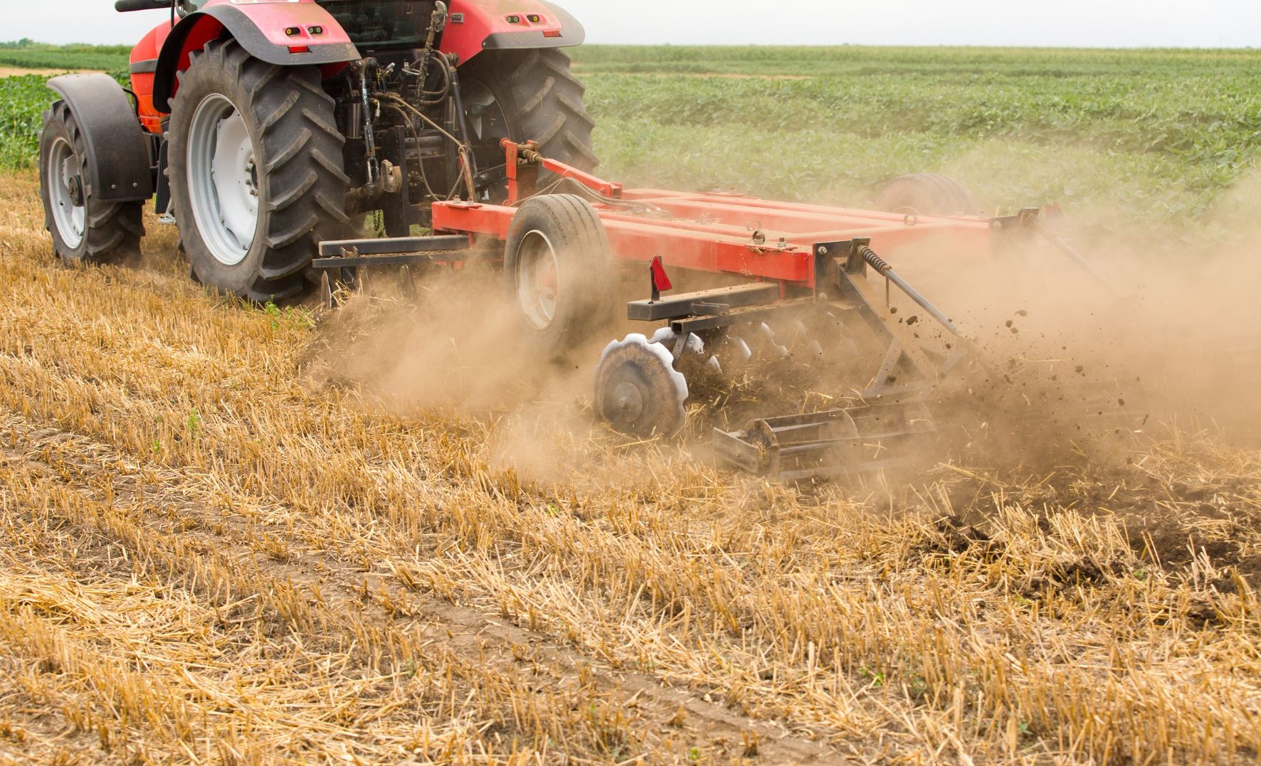 Mechanized Crop Residue Management & Stubble Elimination Mechanized tractor disc tilling and managing post-harvest crop residue in the field